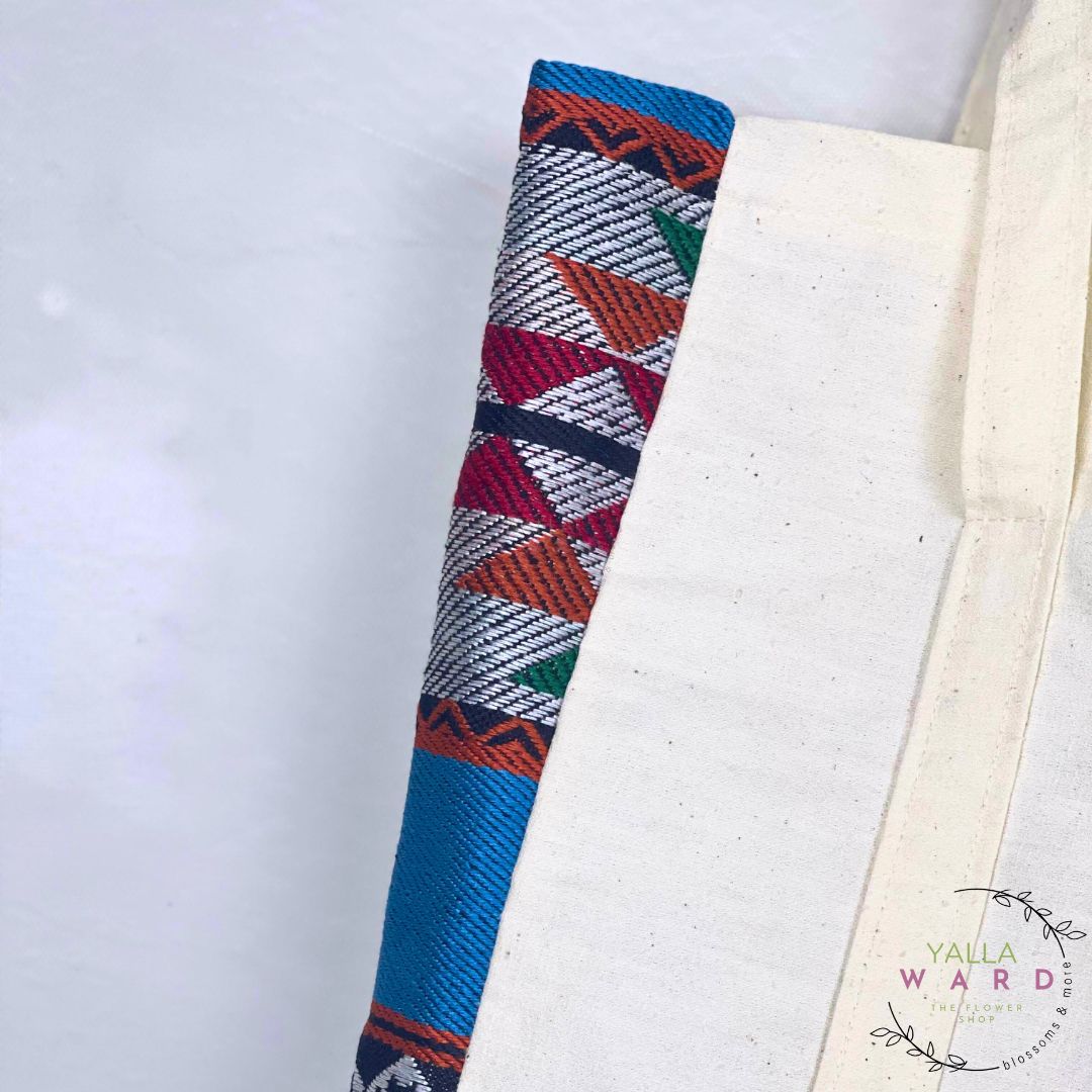 Colorful woven object on a white background with 'Yalla Ward' branding.