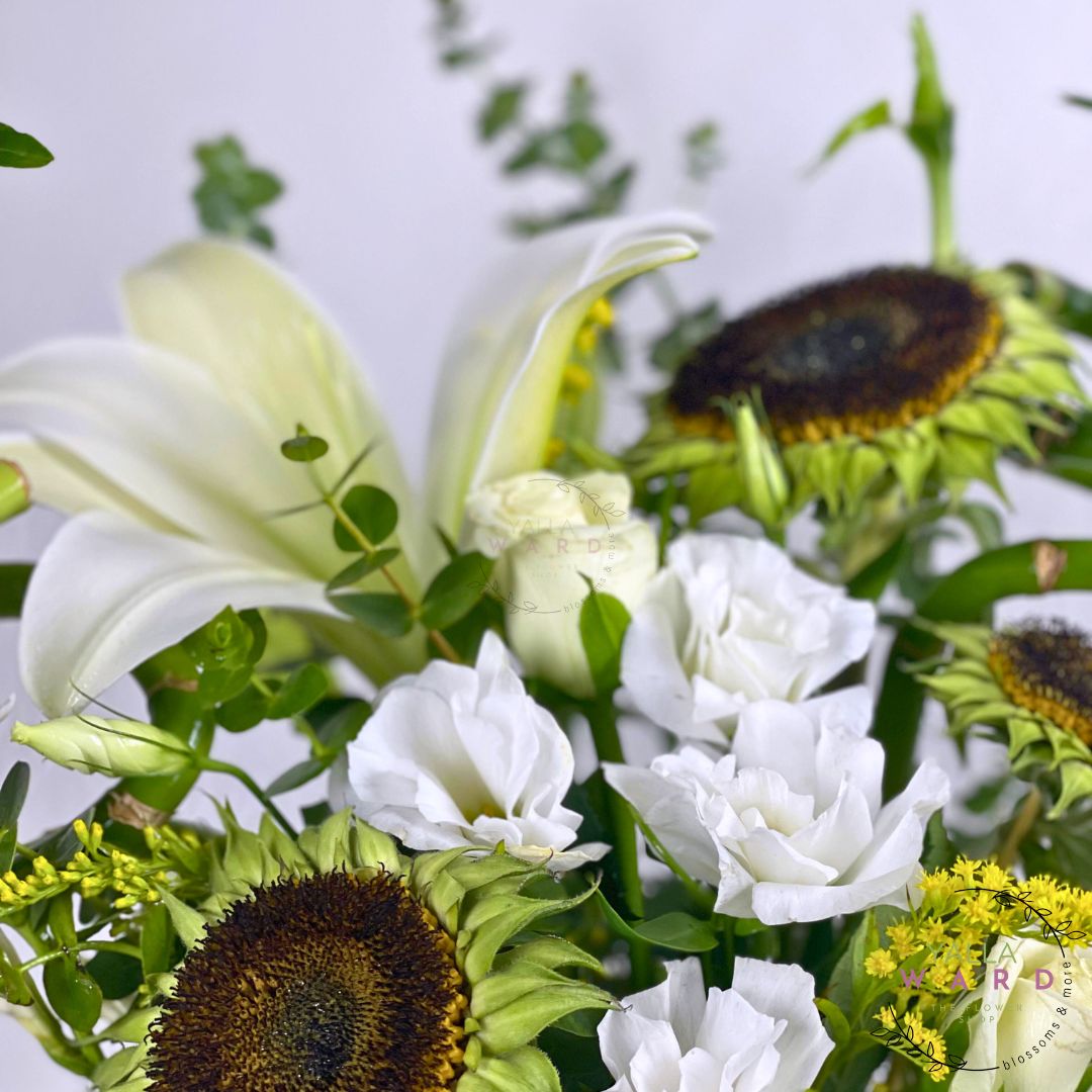 Bouquet of white flowers and sunflowers with a blurred background