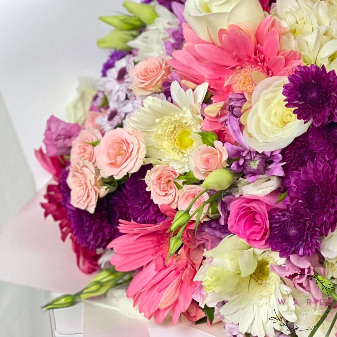 Bouquet of colorful flowers including pink, purple, and white flowers.