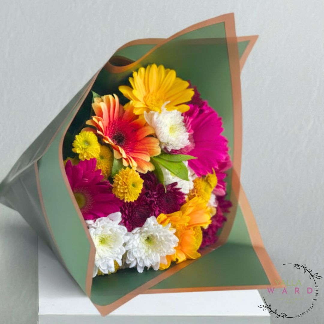 Colorful bouquet of flowers in a decorative paper wrap on a light gray background