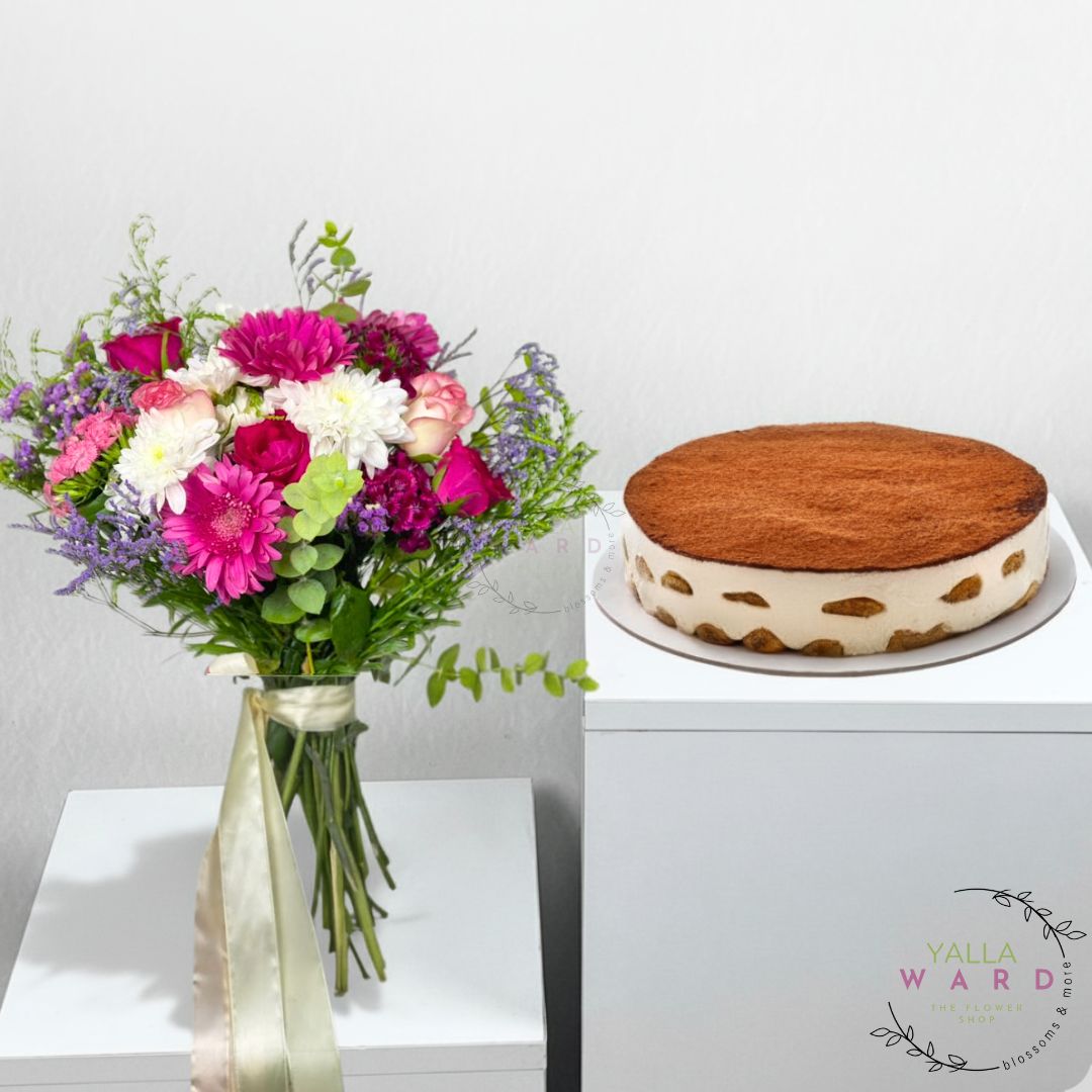 Bouquet of flowers and a cake on a white surface with 'Yalla Ward' branding.