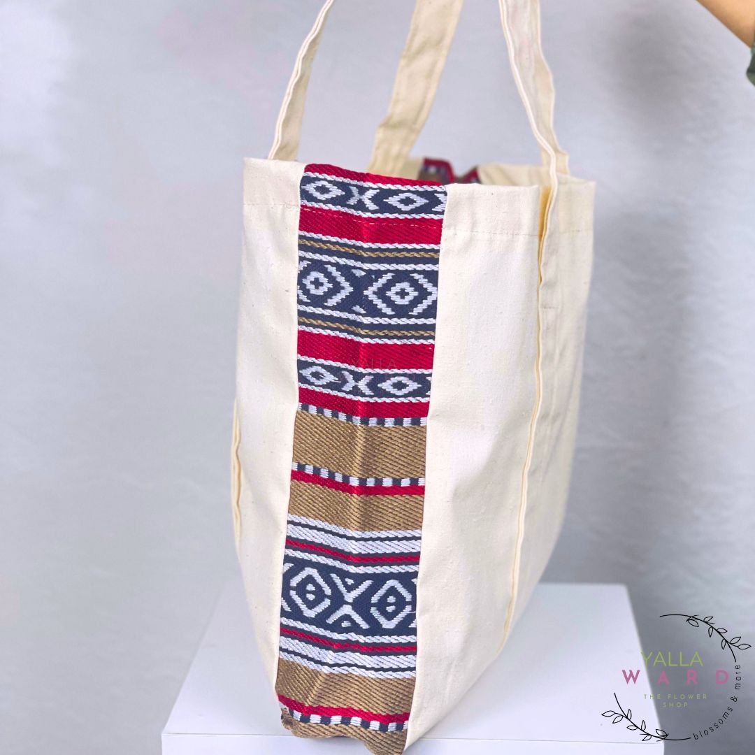 Tote bag with a colorful patterned strip on a white background