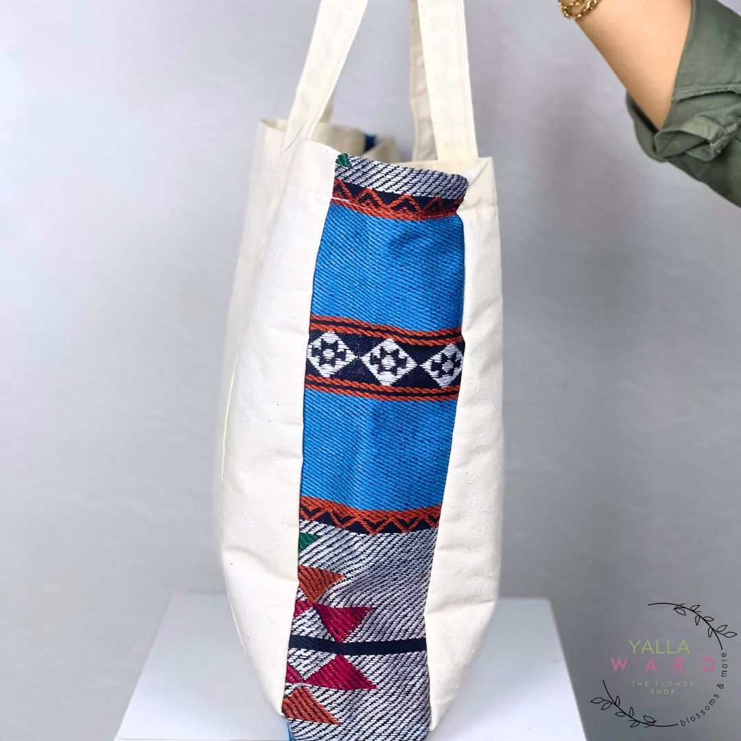 Tote bag with a colorful patterned tube on a white background