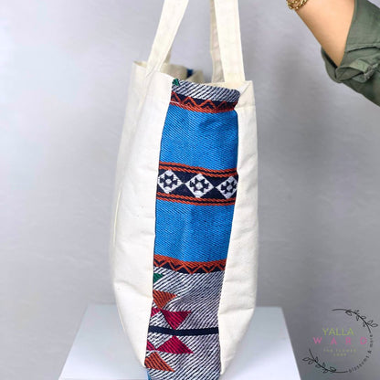 Tote bag with a colorful patterned tube on a white background