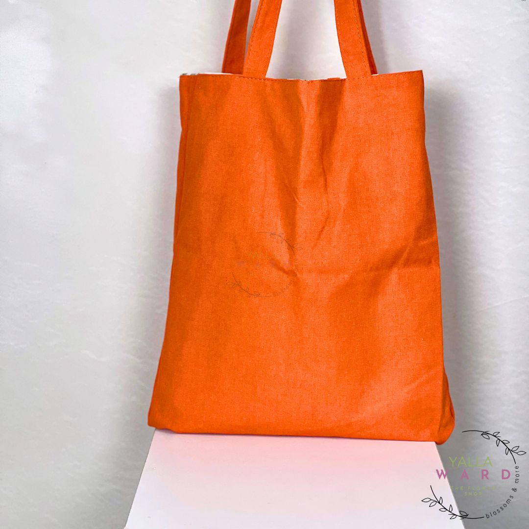 Orange tote bag on a white background