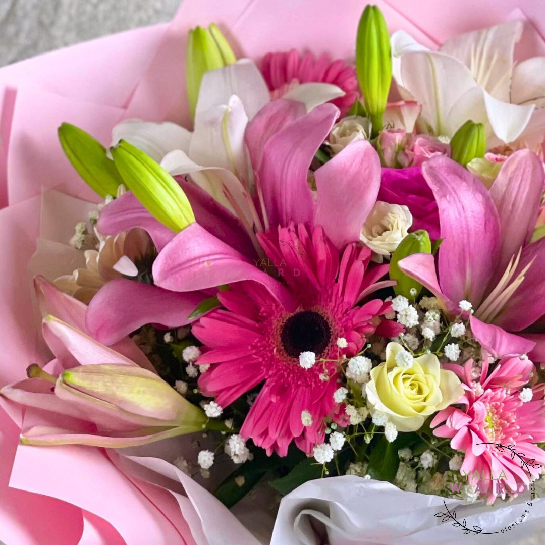 Bouquet of pink and white flowers with a pink ribbon on a light background