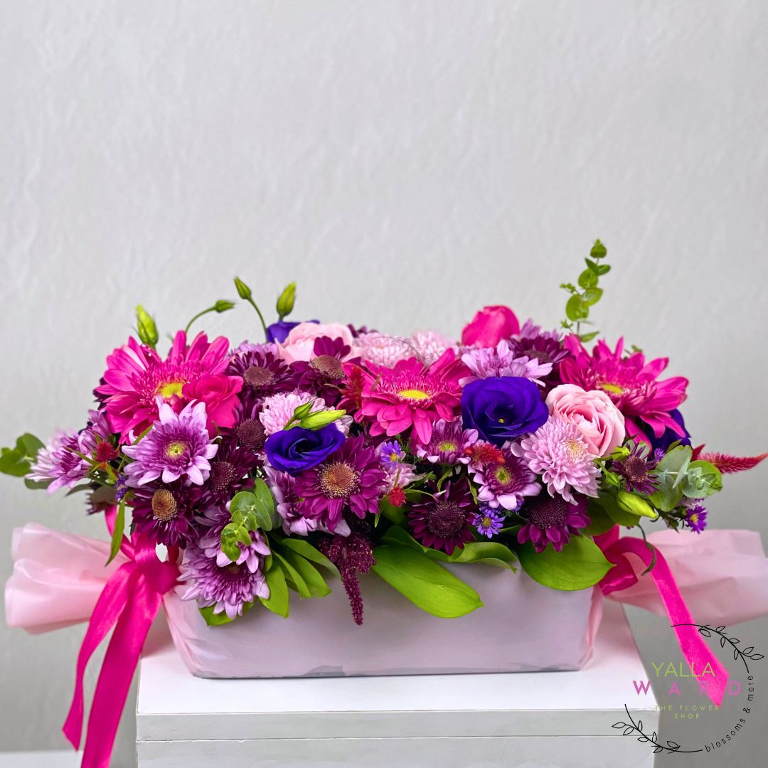 pink flower arrangement with pink and purple tones on a white background