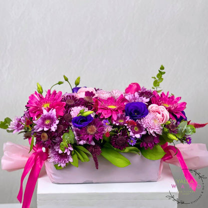 pink flower arrangement with pink and purple tones on a white background