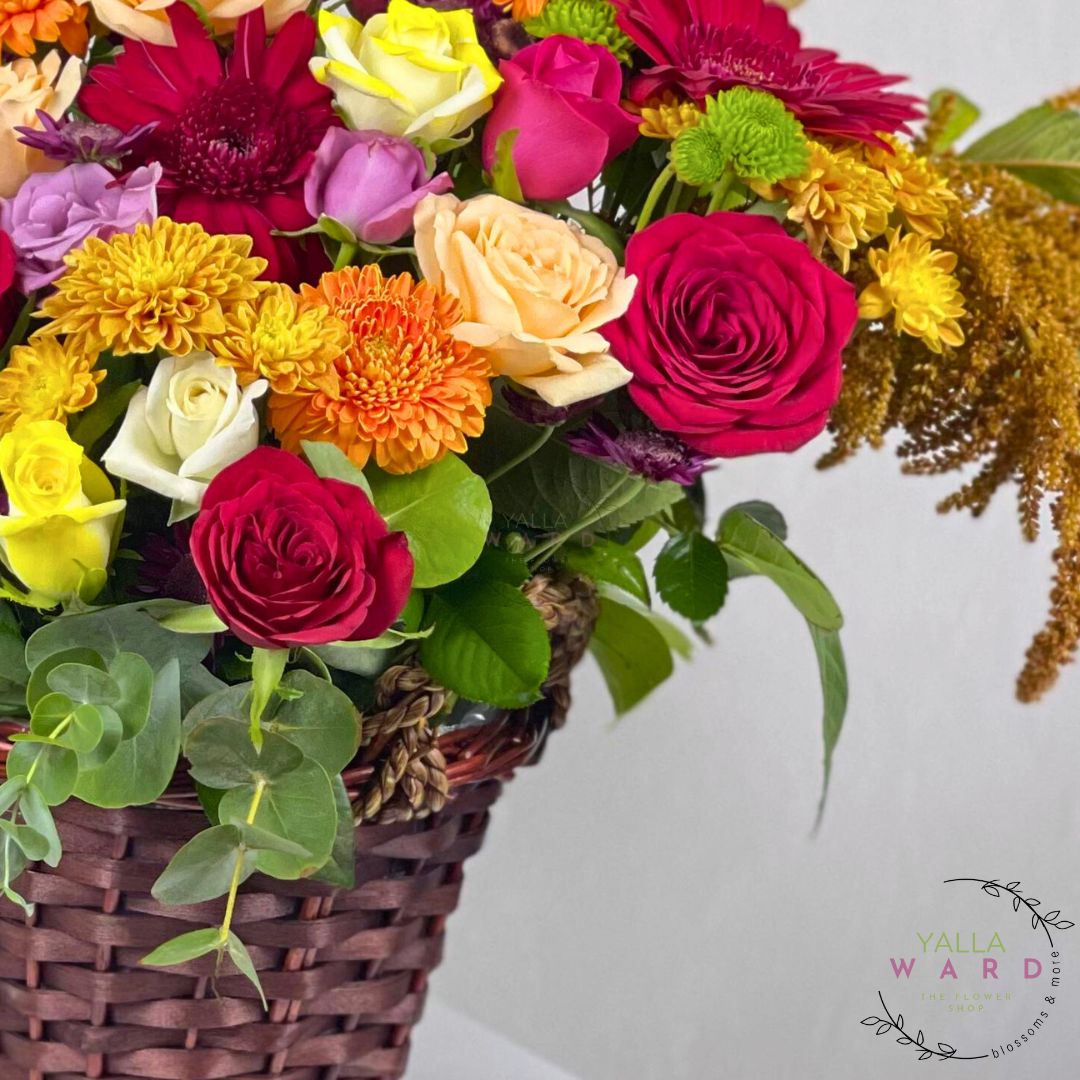 Colorful flower arrangement in a woven basket with a blurred background