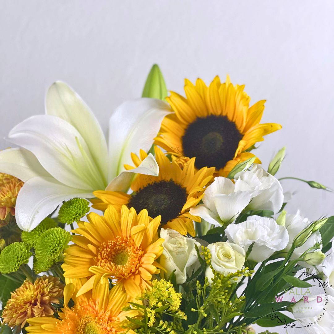 sunflowers, white lilies, and other flowers on a light gray background
