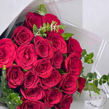 Bouquet of red roses with green leaves , featuring the brand 'Yalla Ward'.
