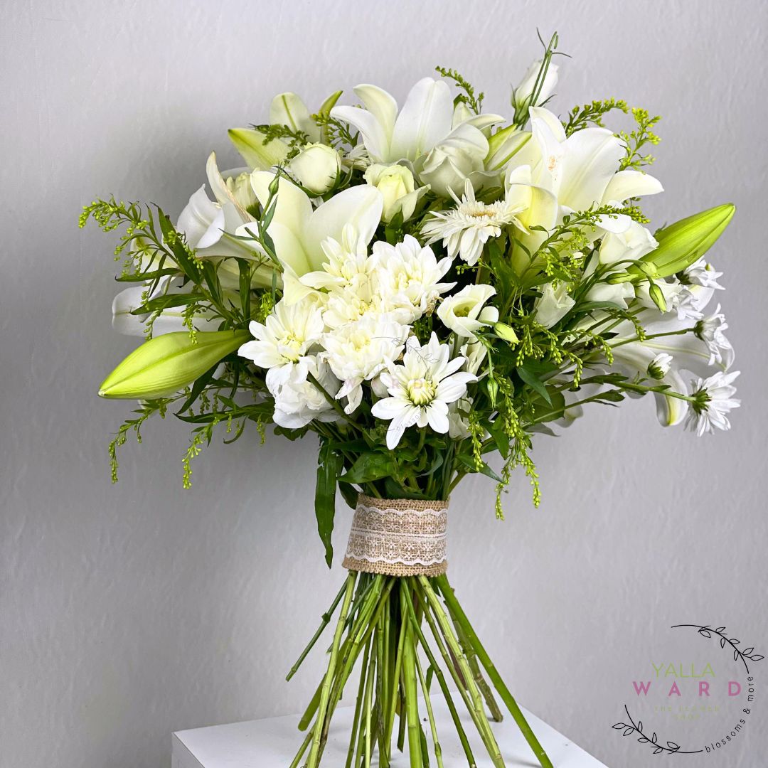 Bouquet of white flowers with greenery on a gray background
