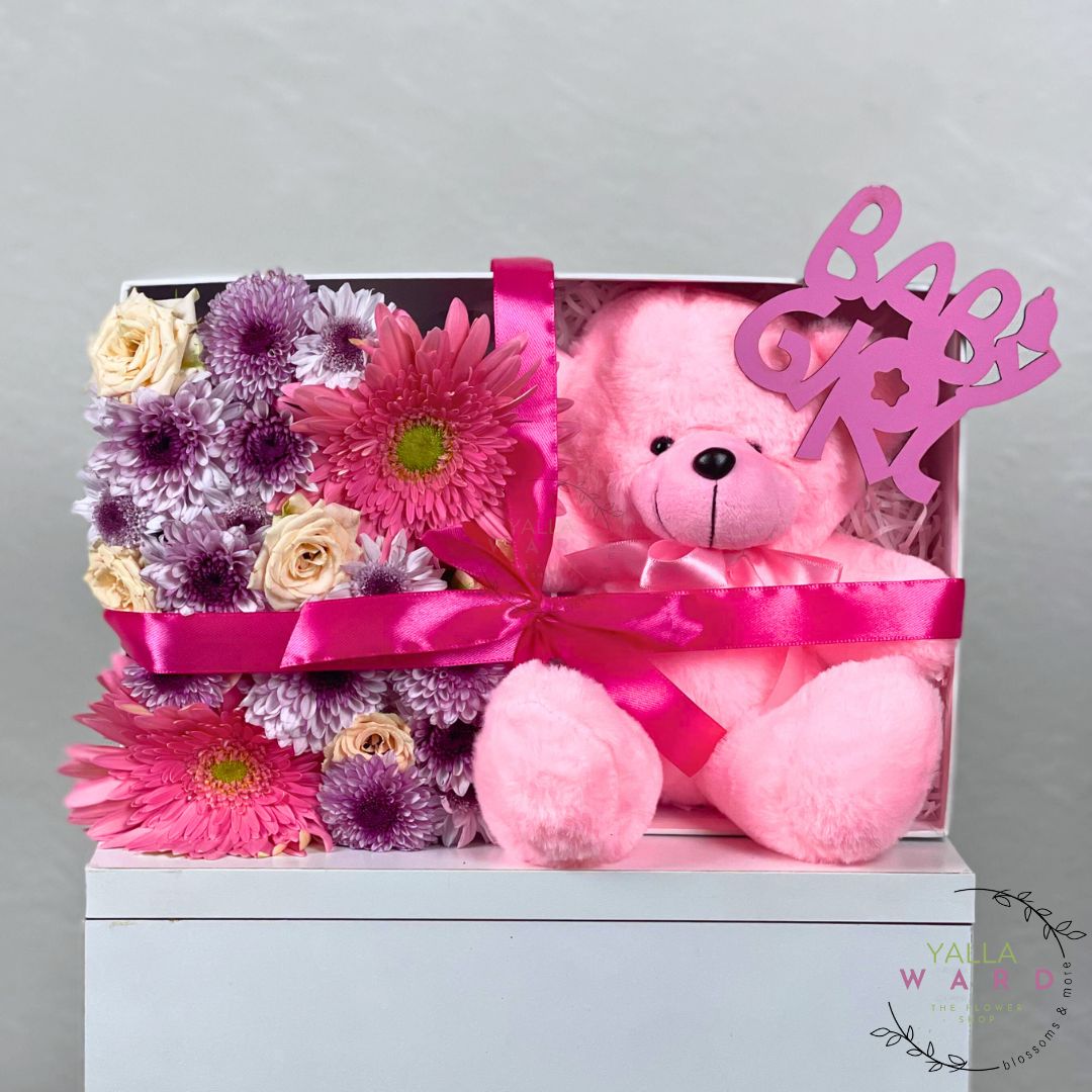 Gift set with pink teddy bear and flowers in a box, featuring a 'Baby Girl' banner.
