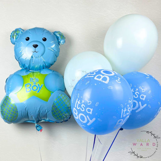 Blue teddy bear balloon with 'It's a Boy' message and matching balloons on a light background