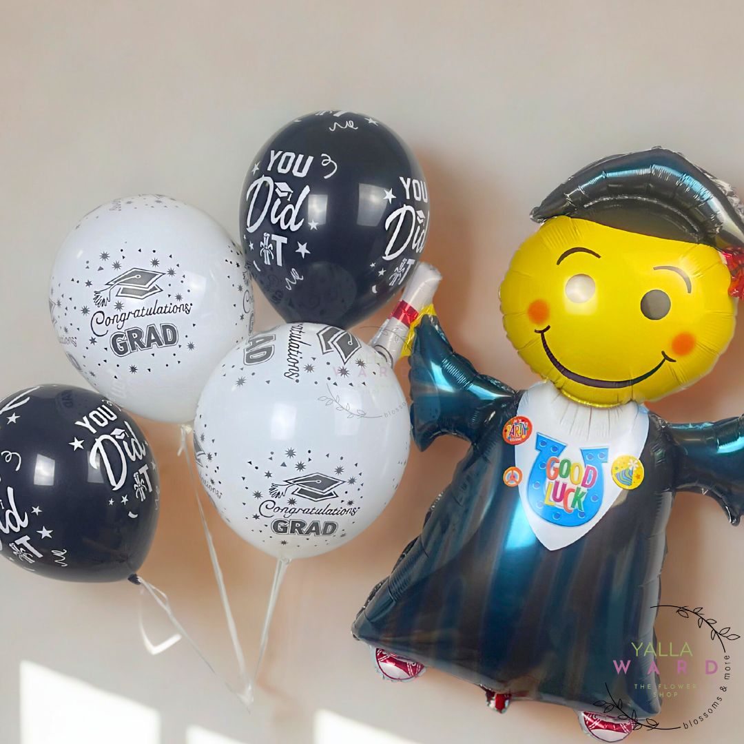 Graduation-themed balloons with 'Congratulations Grad' and 'You Did It!' text on a light background.