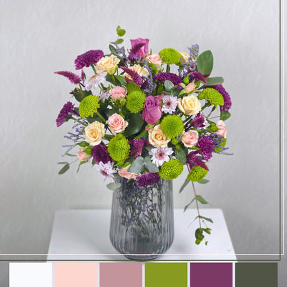 flowers in a vase on a white surface with a light gray background