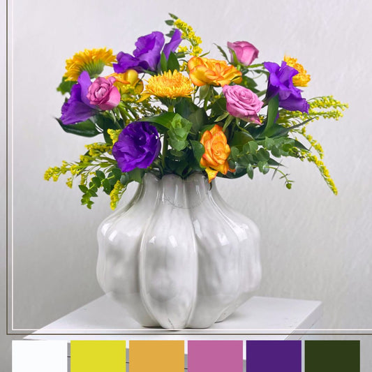 White vase with colorful flowers on a white background