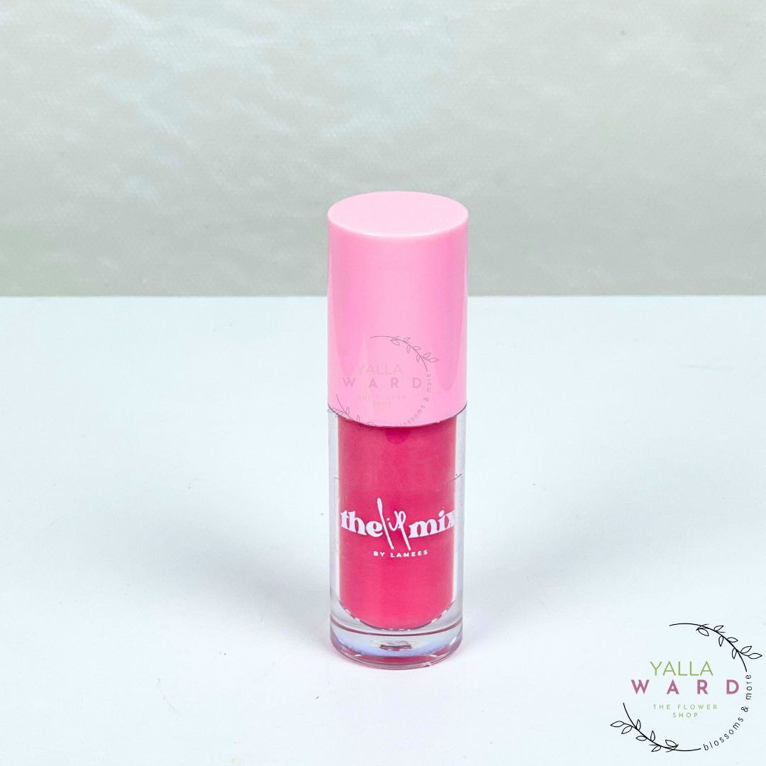 Pink lip gloss with a pink cap on a white background