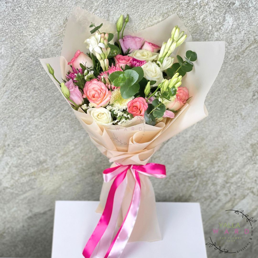 Bouquet of flowers with a pink ribbon on a textured gray background