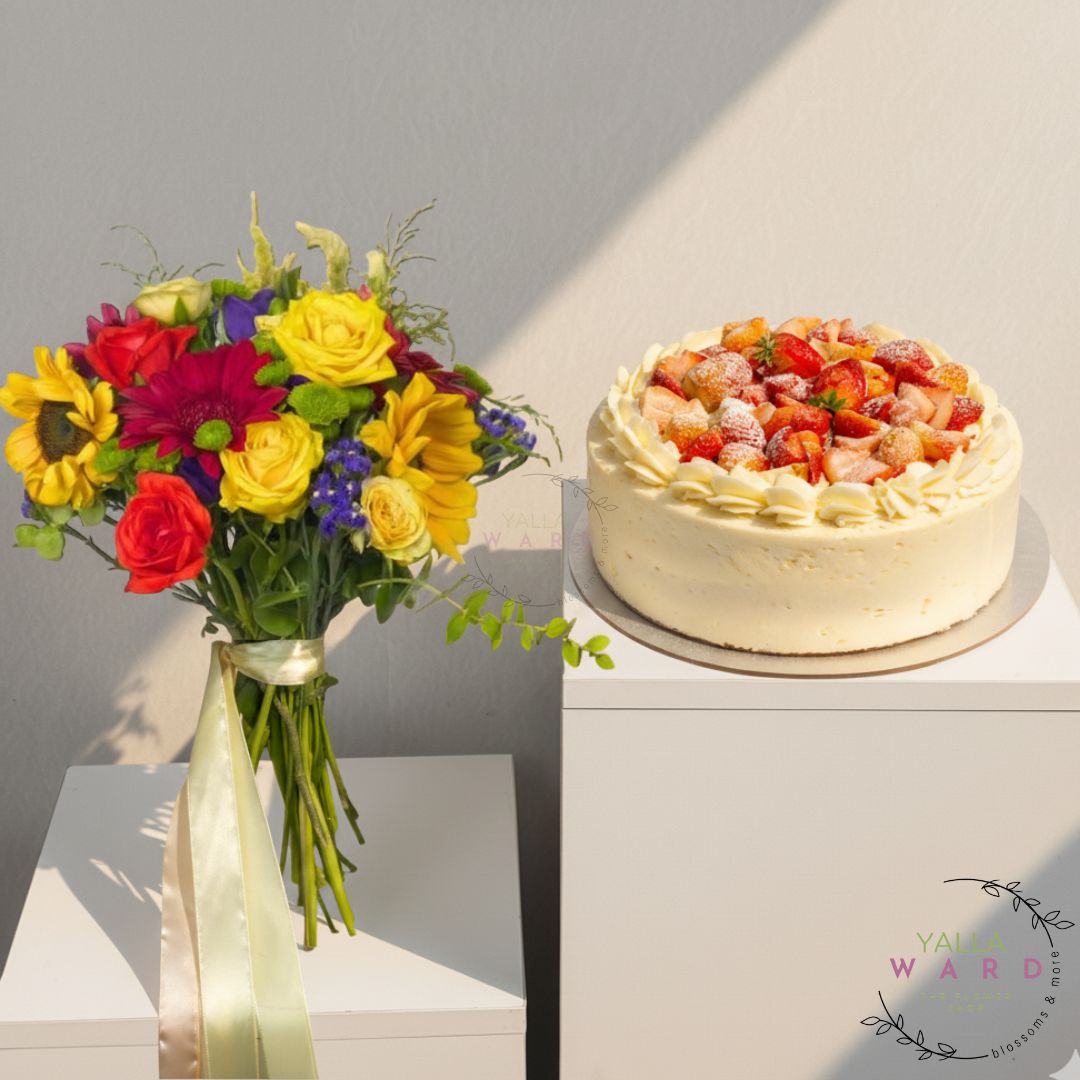 Bouquet of flowers and cake on a white surface with a gray background