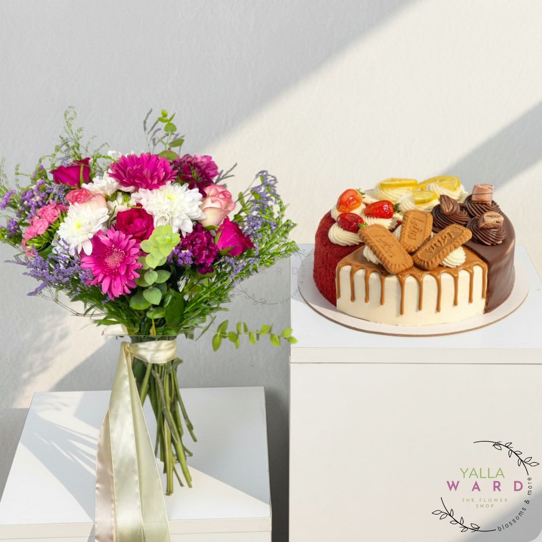 Bouquet of flowers and a decorated cake on a white surface with 'Yalla Ward' branding.